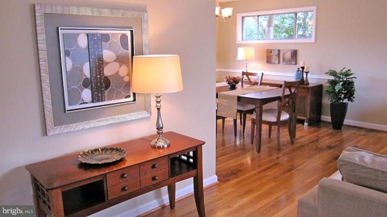 6115 Greentree Road Bethesda, MD 20817 - Photo 7 of 19 a view of a dining room with furniture and wooden floor