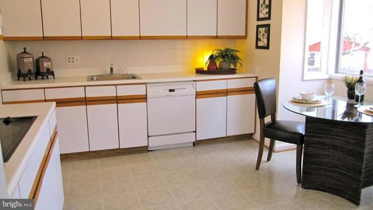 6115 Greentree Road Bethesda, MD 20817 - Photo 8 of 19 a kitchen with a sink cabinets and window