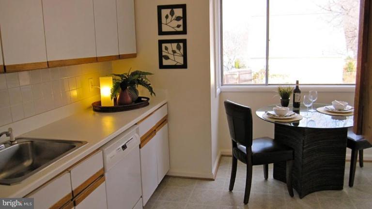 6115 Greentree Road Bethesda, MD 20817 - Photo 9 of 19 a kitchen with a sink cabinets and window
