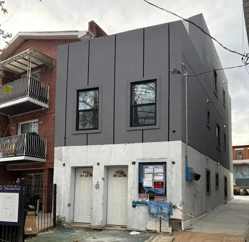 a front view of a building with glass windows and door
