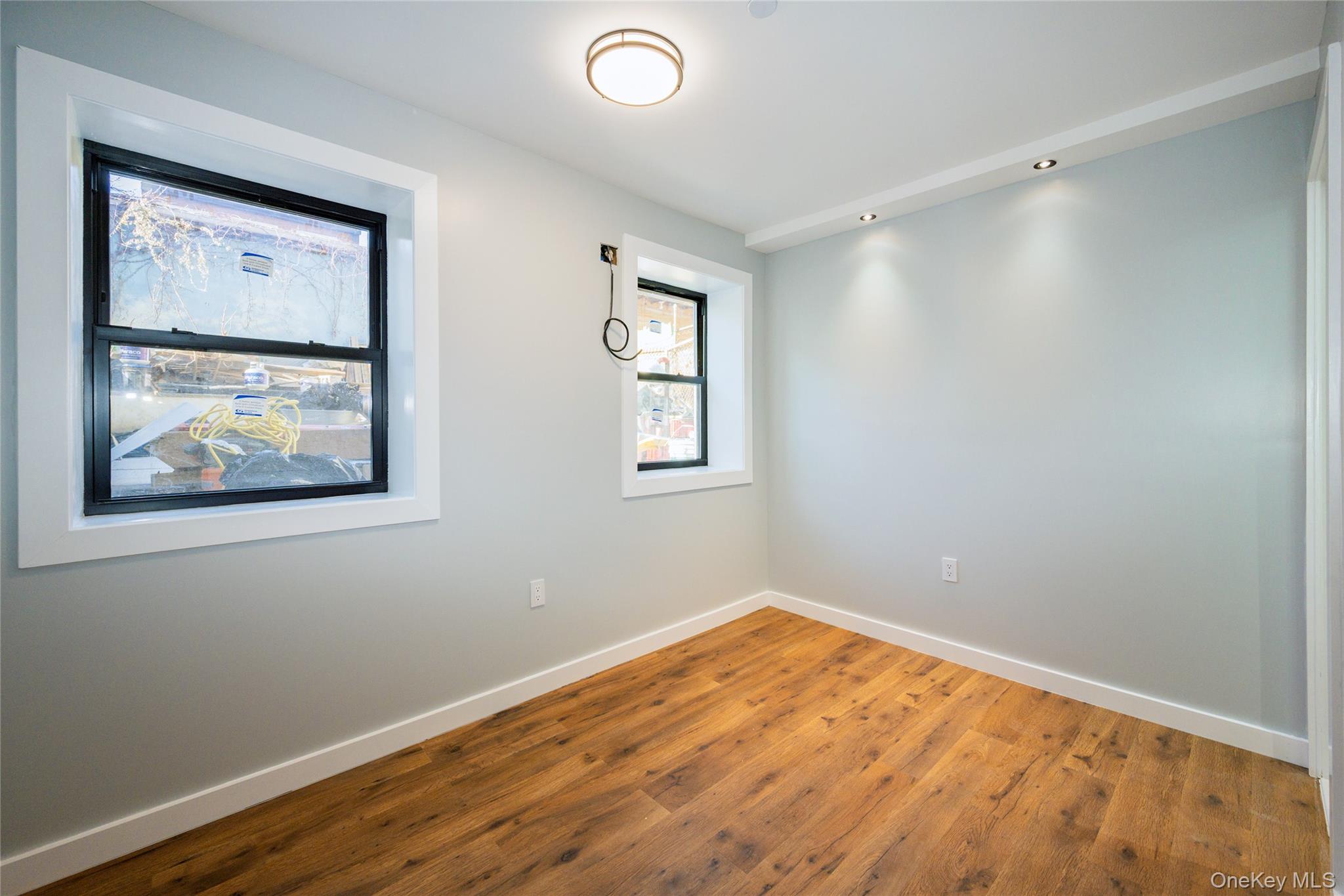 33-34 109th Street Queens, NY 11368 - Photo 17 of 26 a view of empty room with wooden floor