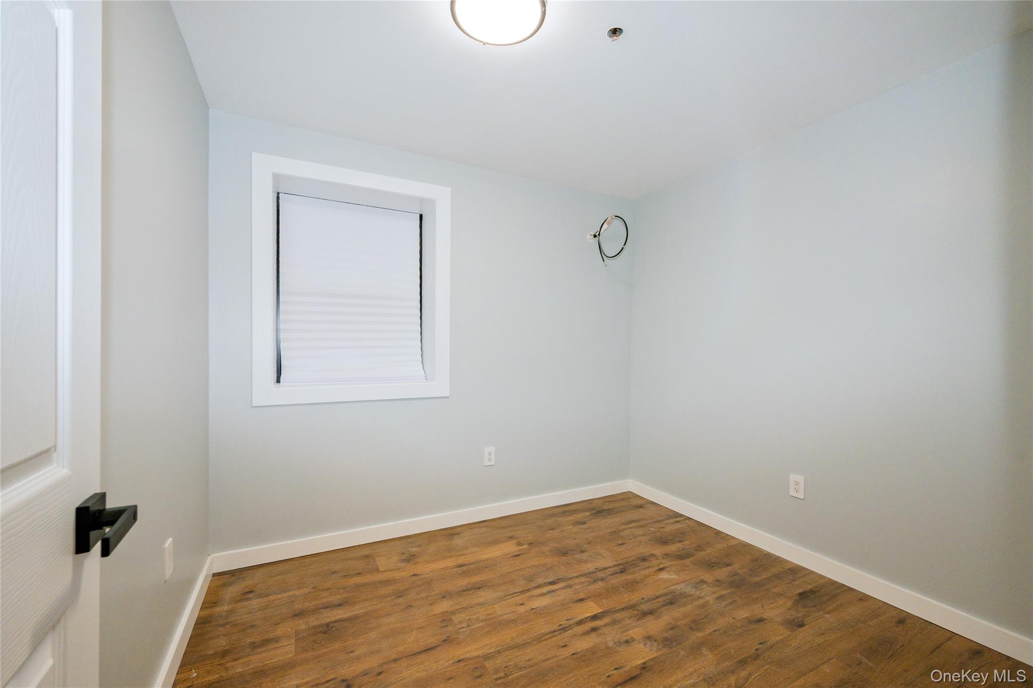 33-34 109th Street Queens, NY 11368 - Photo 20 of 26 a view of empty room with wooden floor
