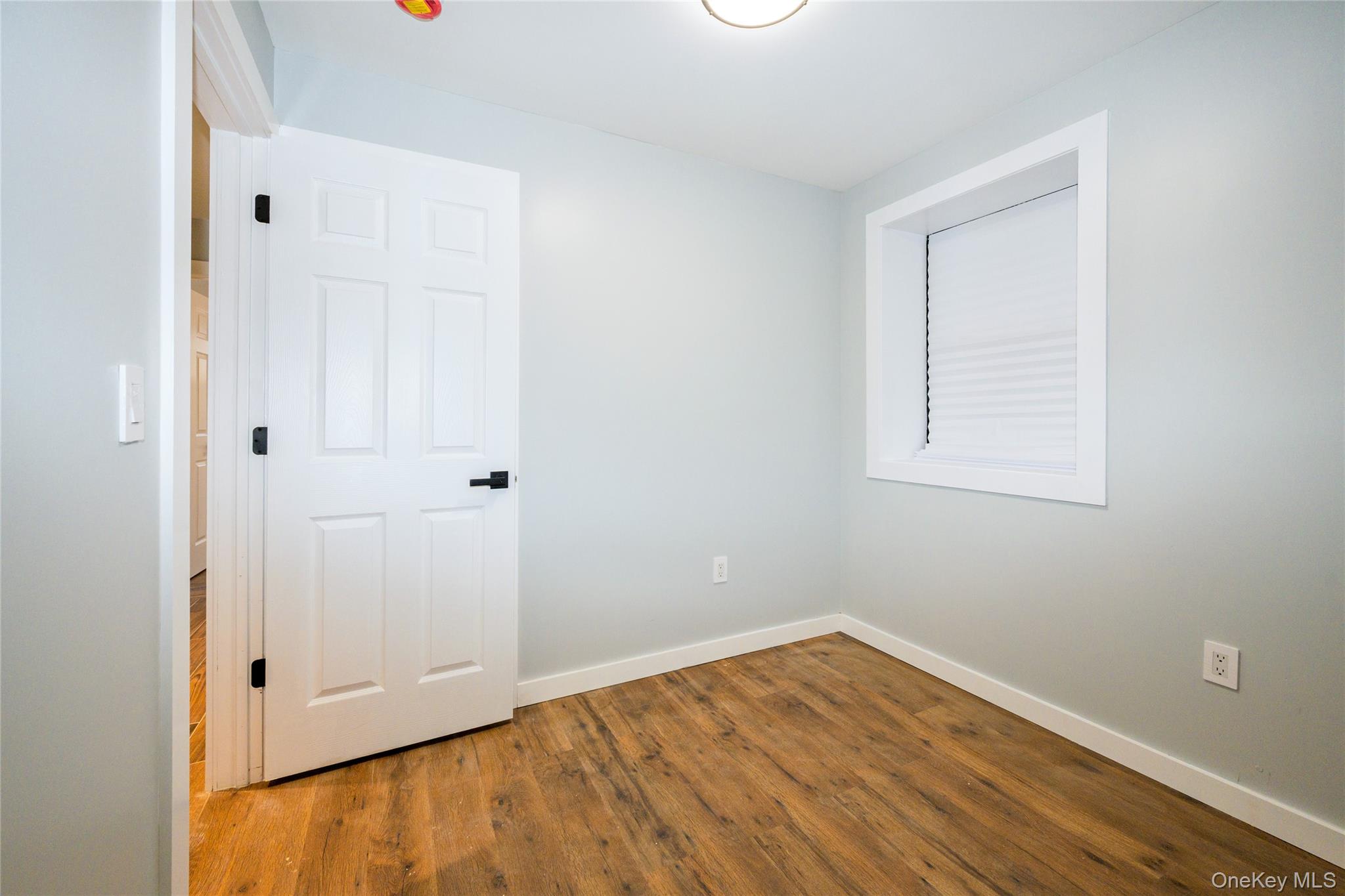 33-34 109th Street Queens, NY 11368 - Photo 21 of 26 an empty room with wooden floor and closet