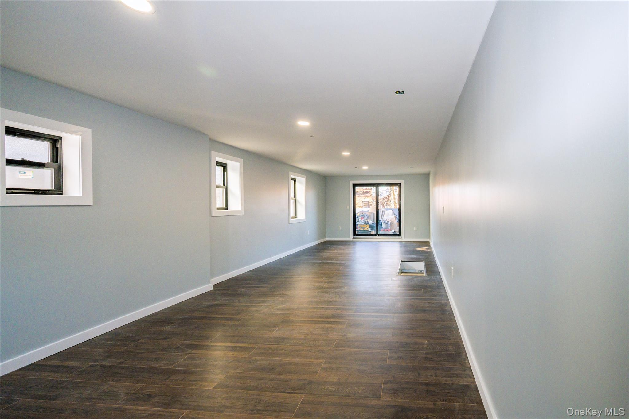 33-34 109th Street Queens, NY 11368 - Photo 25 of 26 a view of an empty room with wooden floor and window