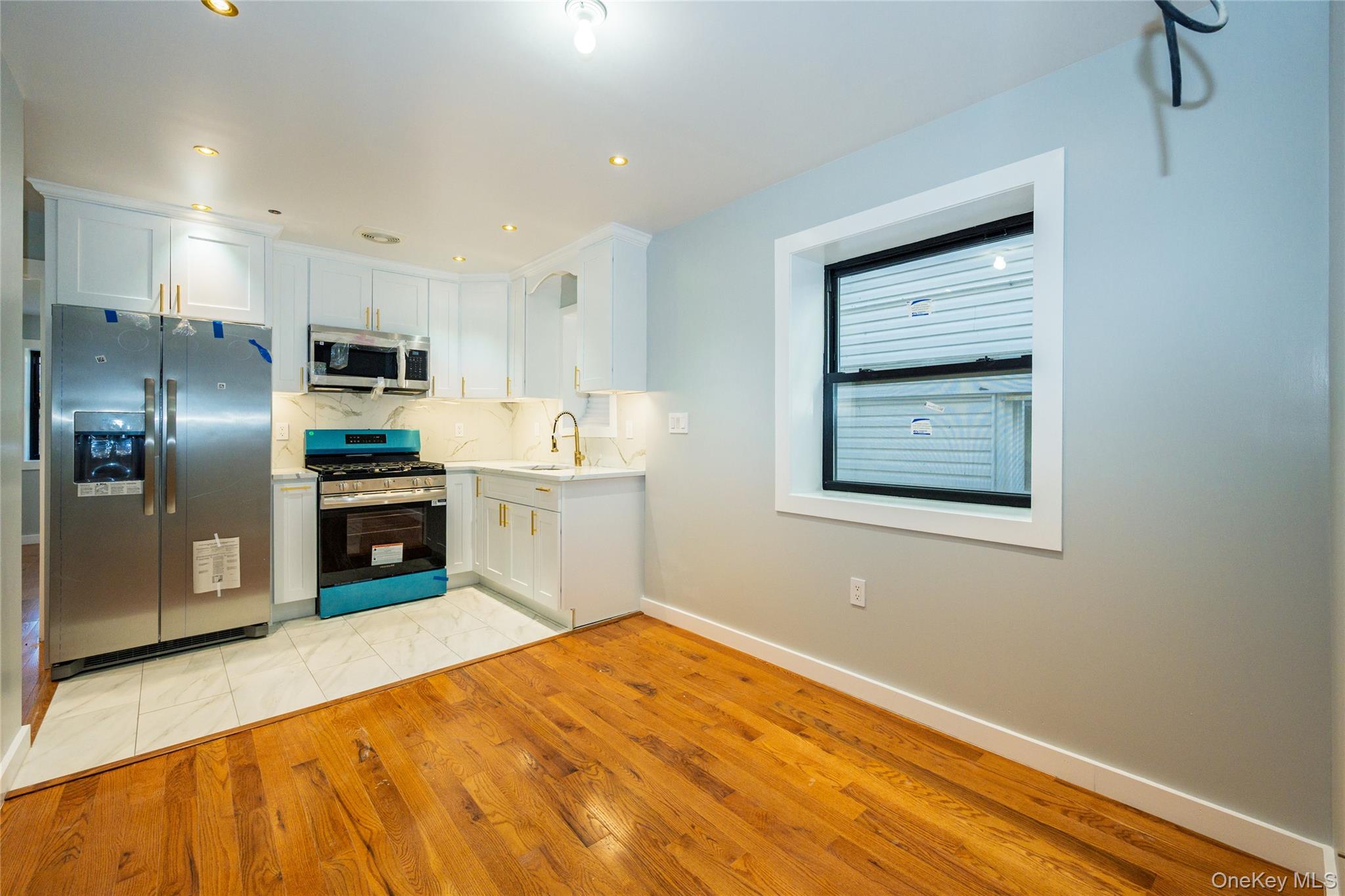 33-34 109th Street Queens, NY 11368 - Photo 6 of 26 a kitchen with stainless steel appliances a refrigerator and a stove top oven