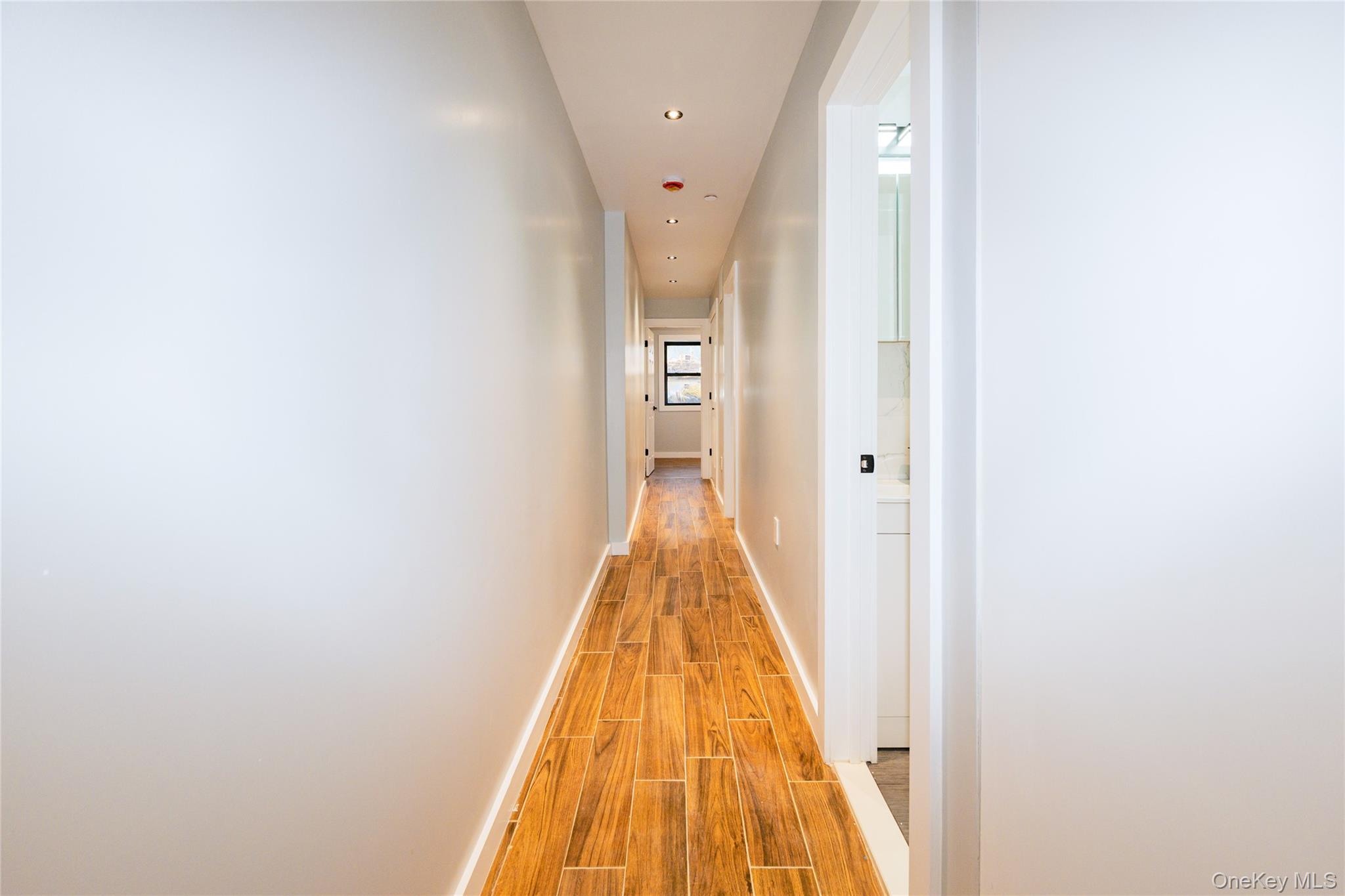 33-34 109th Street Queens, NY 11368 - Photo 10 of 26 a view of a hallway with wooden floor