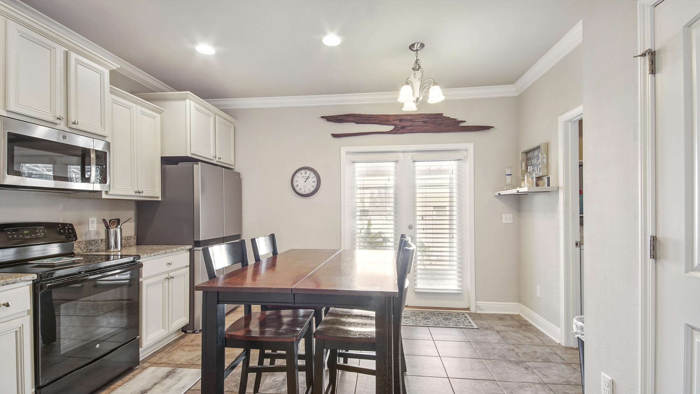30 Grayling Way Inlet Beach, FL 32461 - Photo 8 of 26 a kitchen with stainless steel appliances granite countertop a dining table chairs refrigerator and cabinets