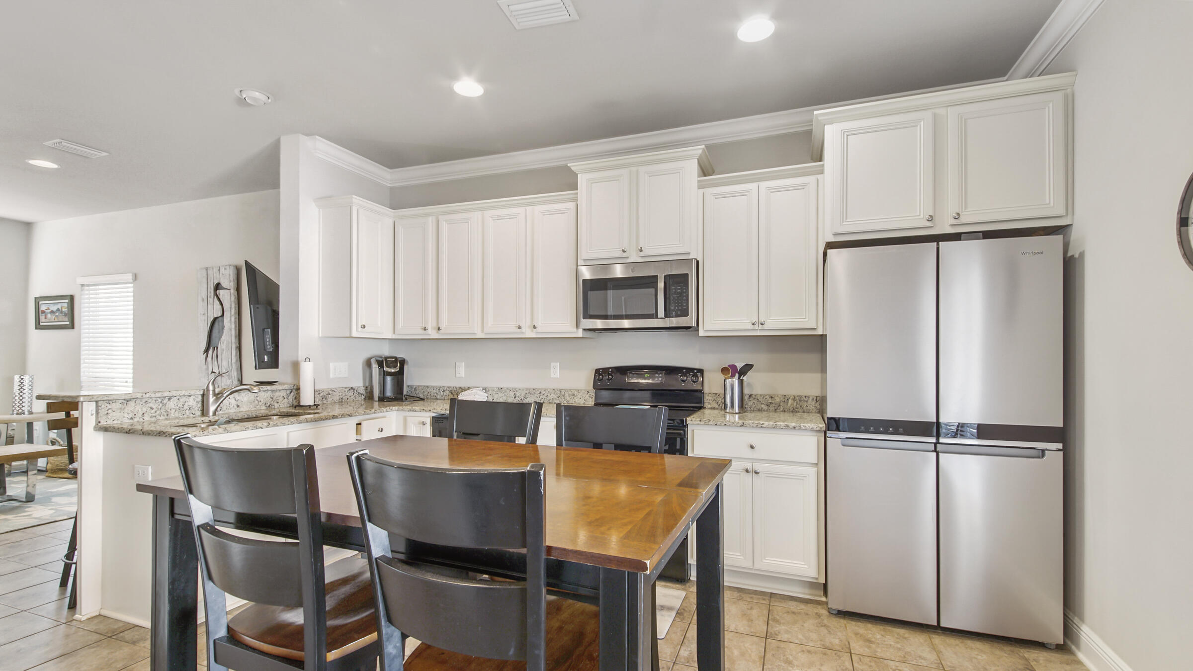 30 Grayling Way Inlet Beach, FL 32461 - Photo 10 of 26 a kitchen with stainless steel appliances granite countertop a refrigerator a sink a stove a microwave and white cabinets with wooden floor