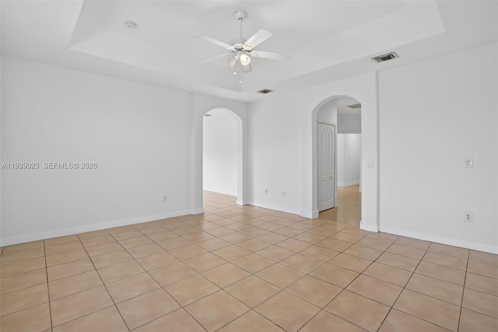15051 Southwest 18th Terrace Miami, FL 33185 - Photo 21 of 42 an empty room with white walls and ceiling fan