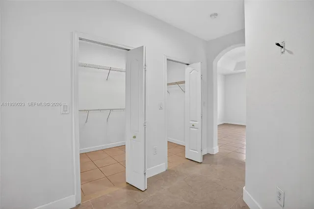 a white toilet sitting next to a white wall