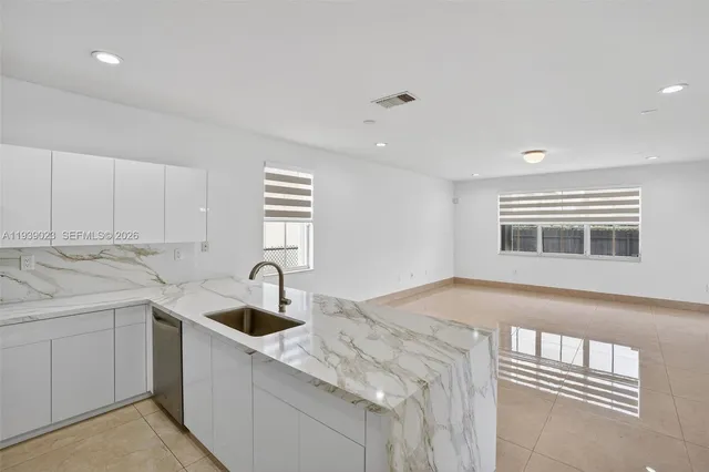 a kitchen with a sink and cabinets