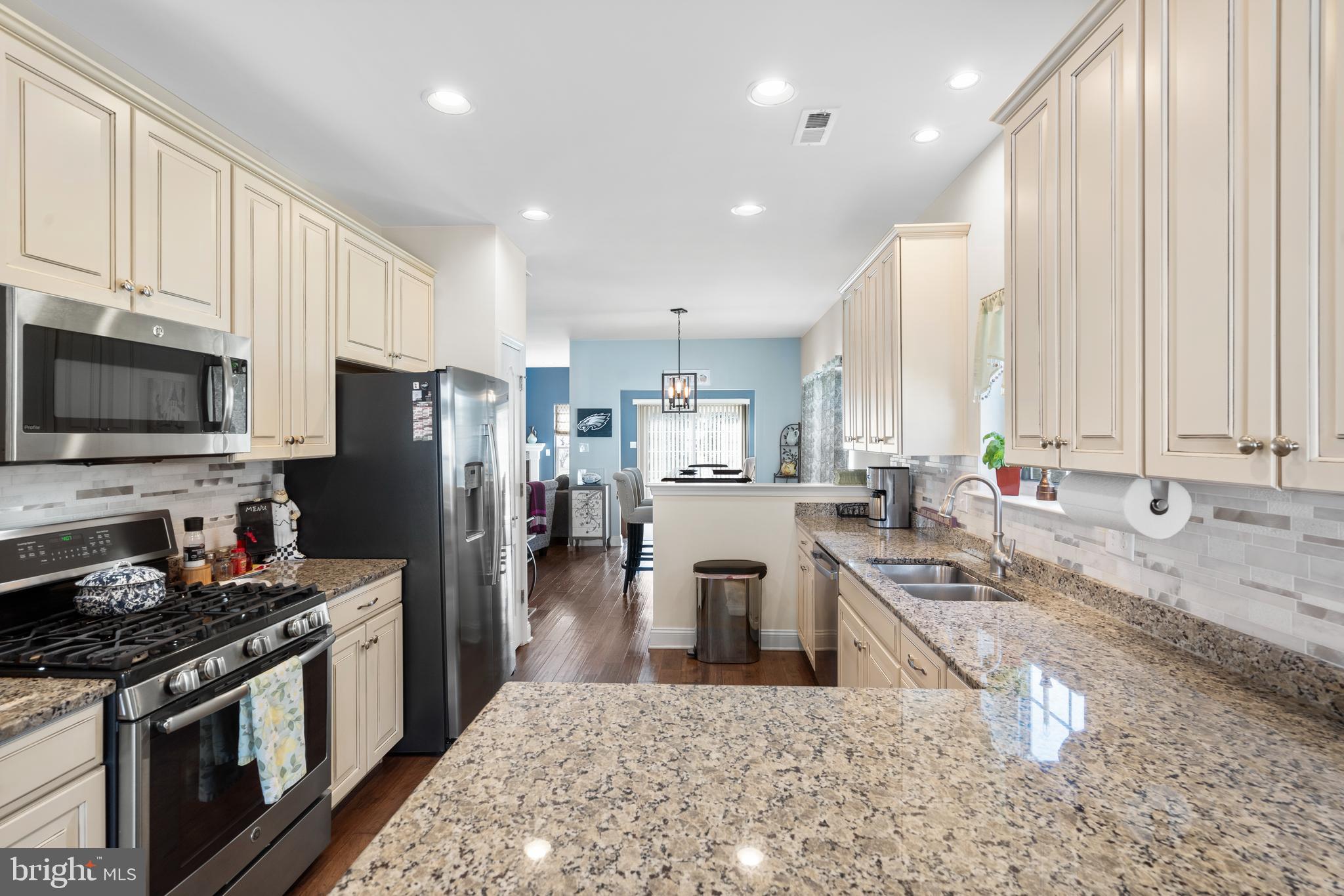 118 Field Loop Glassboro, NJ 08028 - Photo 7 of 51 a large kitchen with stainless steel appliances granite countertop a stove a sink a refrigerator and white cabinets