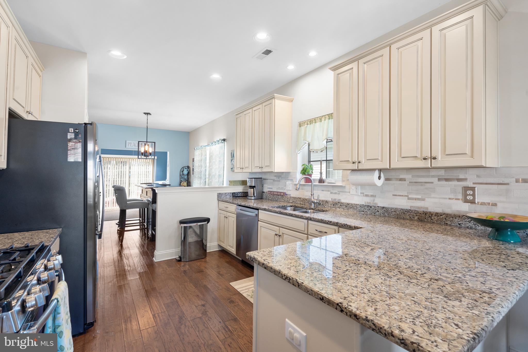 118 Field Loop Glassboro, NJ 08028 - Photo 8 of 51 a kitchen with a refrigerator a sink and wooden cabinets