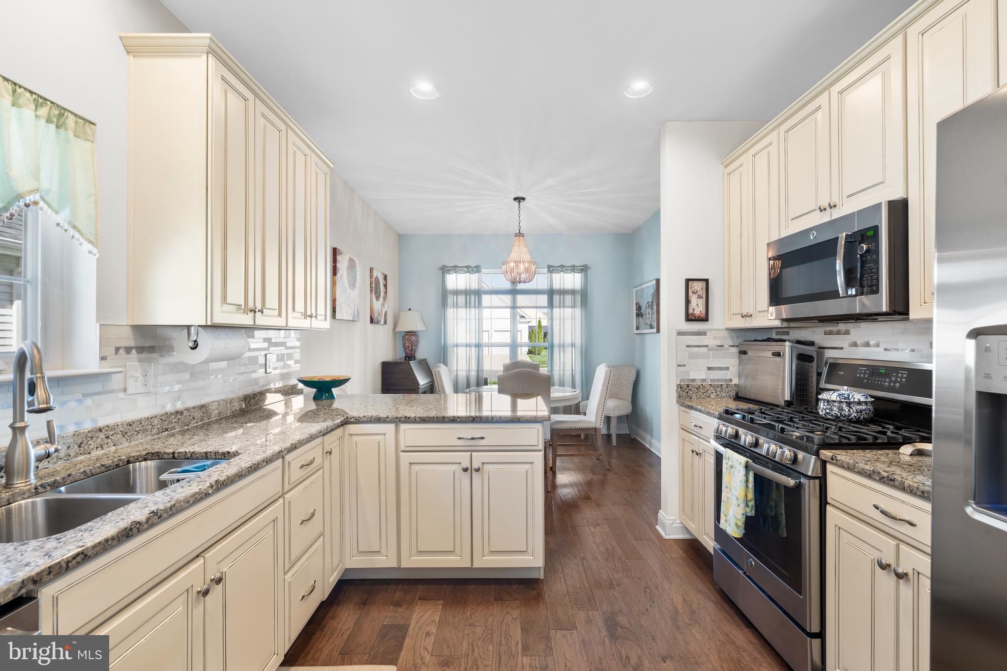 118 Field Loop Glassboro, NJ 08028 - Photo 9 of 51 a kitchen with stainless steel appliances kitchen island granite countertop a sink a stove top oven a refrigerator cabinets and a window