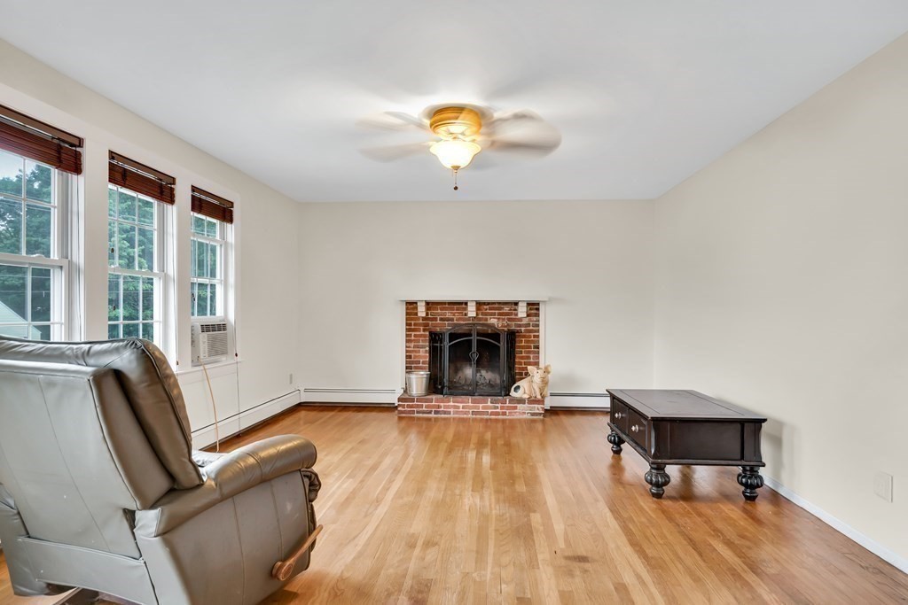184 West Acton Road Stow, MA 01775 - Photo 11 of 35 a living room with furniture and a fireplace