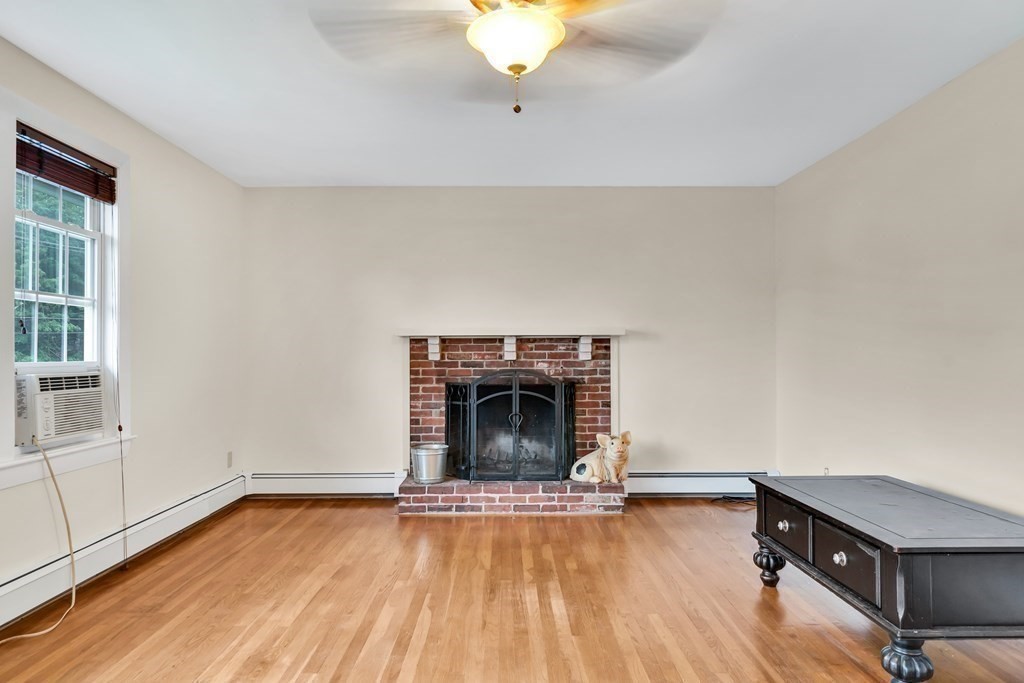 184 West Acton Road Stow, MA 01775 - Photo 12 of 35 a living room with furniture and a fireplace