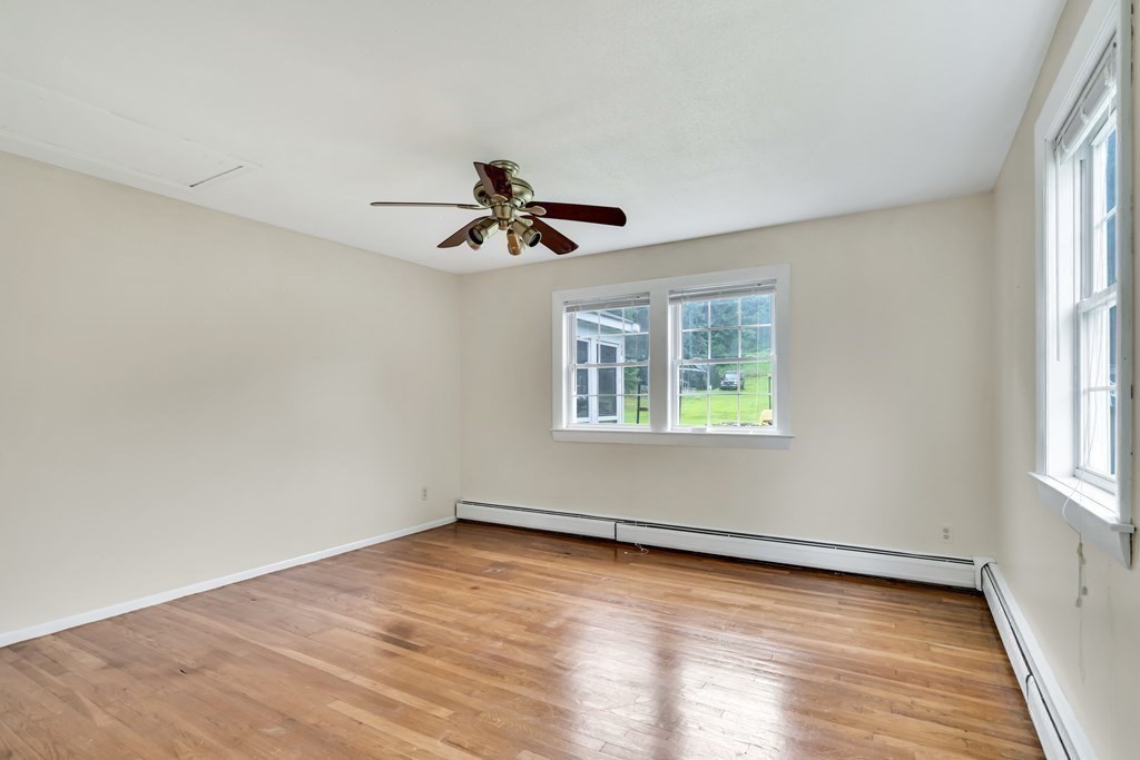 184 West Acton Road Stow, MA 01775 - Photo 18 of 35 wooden floor in an empty room with a window