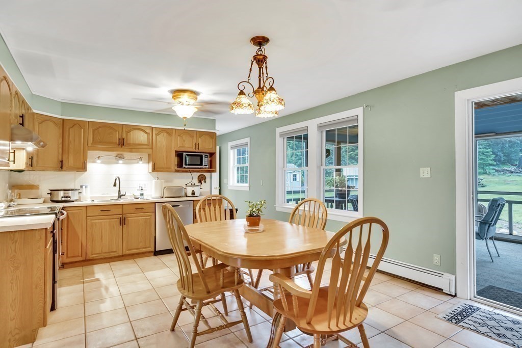 184 West Acton Road Stow, MA 01775 - Photo 19 of 35 a dining room with stainless steel appliances granite countertop a dining table and chairs