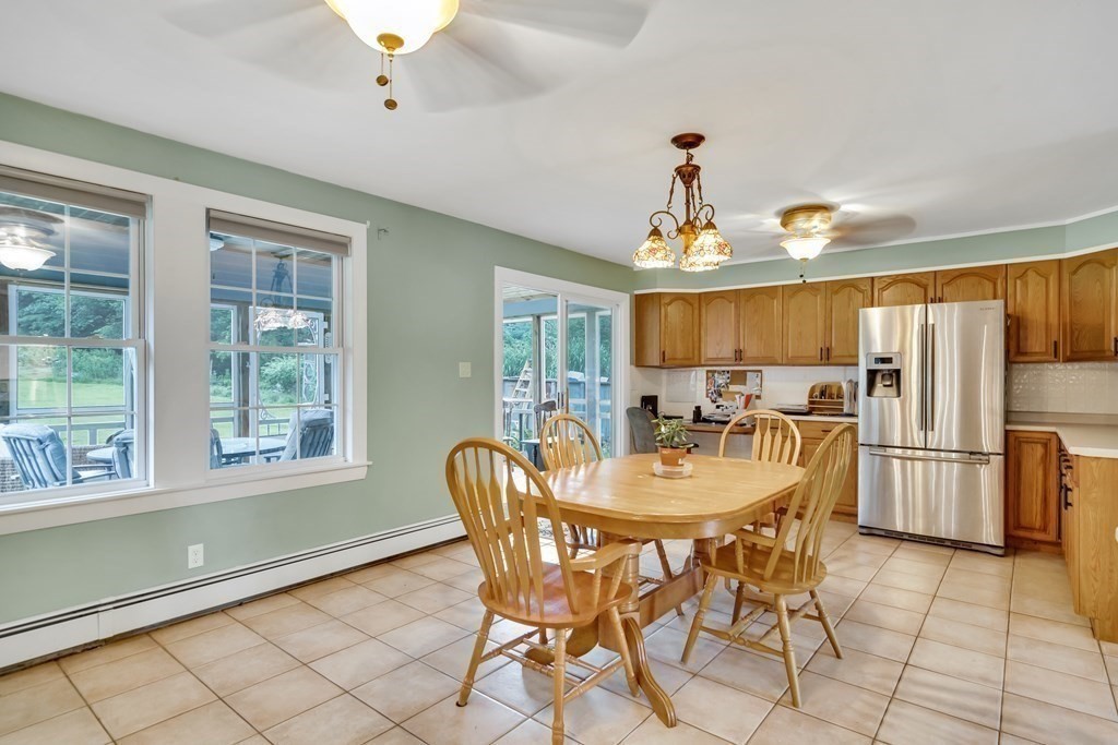 184 West Acton Road Stow, MA 01775 - Photo 20 of 35 a dining room with furniture a chandelier and window