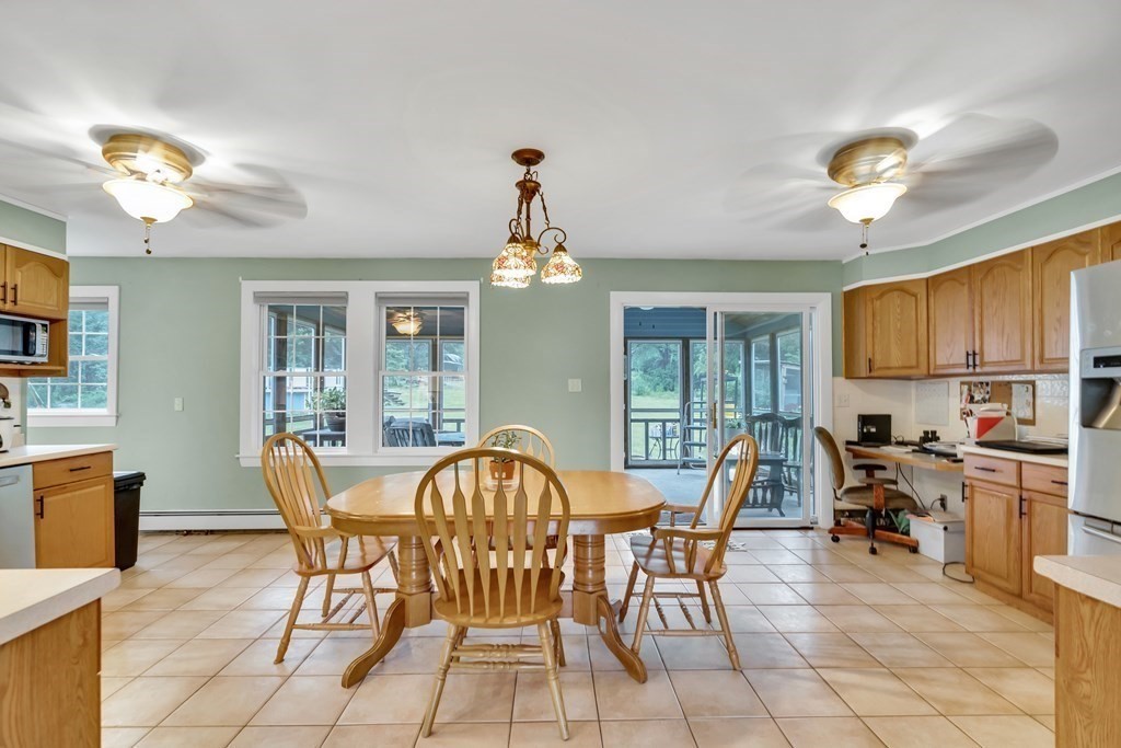 184 West Acton Road Stow, MA 01775 - Photo 2 of 35 a view of a dining room with furniture a chandelier and wooden floor