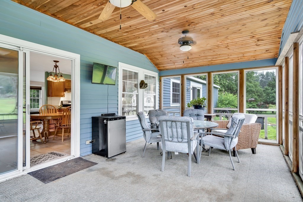 184 West Acton Road Stow, MA 01775 - Photo 24 of 35 a view of a patio with a dining table and chairs