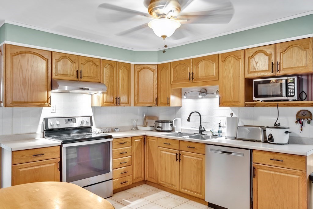 184 West Acton Road Stow, MA 01775 - Photo 3 of 35 a kitchen with granite countertop a sink stainless steel appliances and cabinets