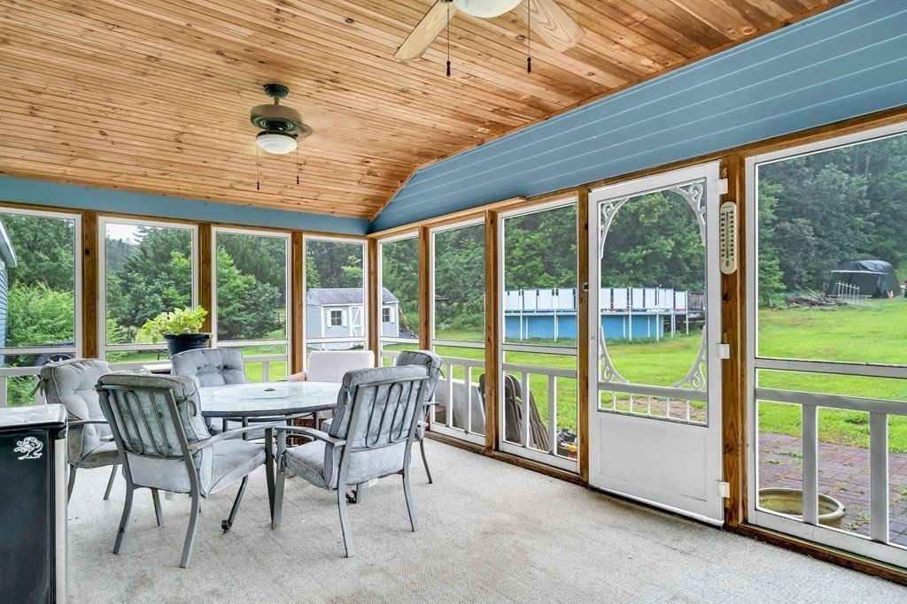 184 West Acton Road Stow, MA 01775 - Photo 4 of 35 a view of a dining room with furniture large windows and wooden floor
