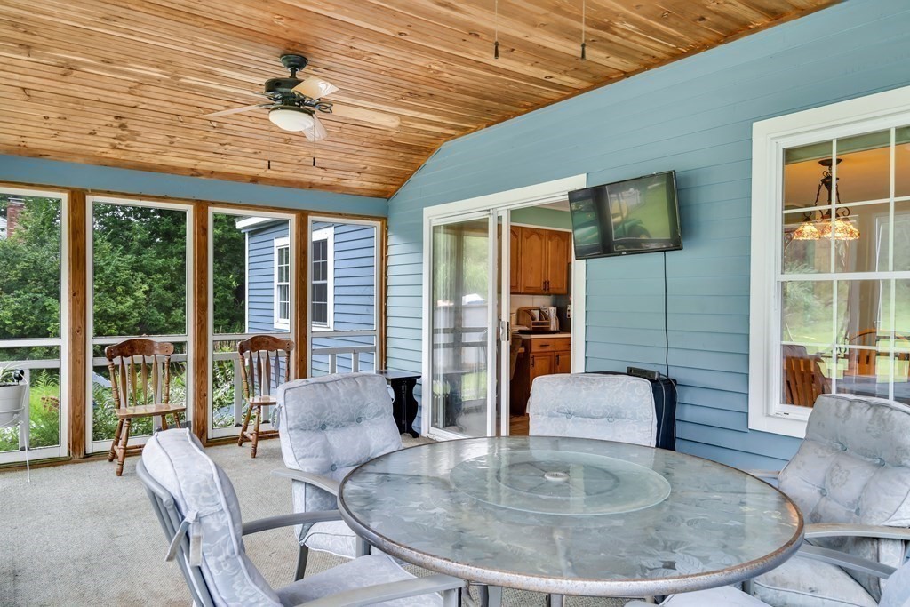 184 West Acton Road Stow, MA 01775 - Photo 8 of 35 a dining room with furniture a chandelier and wooden floor