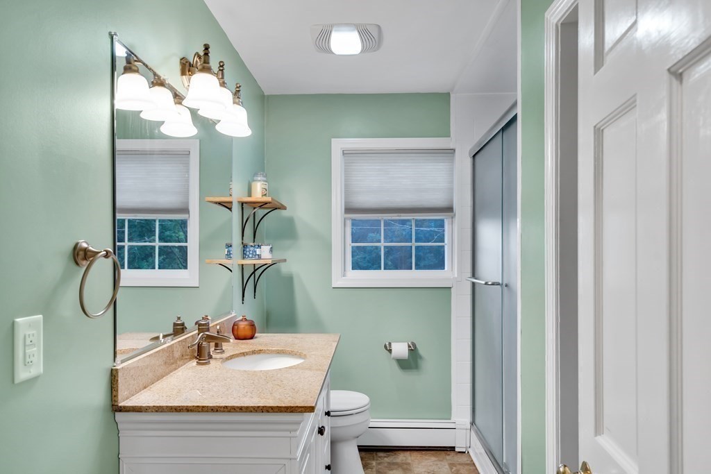 184 West Acton Road Stow, MA 01775 - Photo 9 of 35 a bathroom with a sink a toilet and a mirror