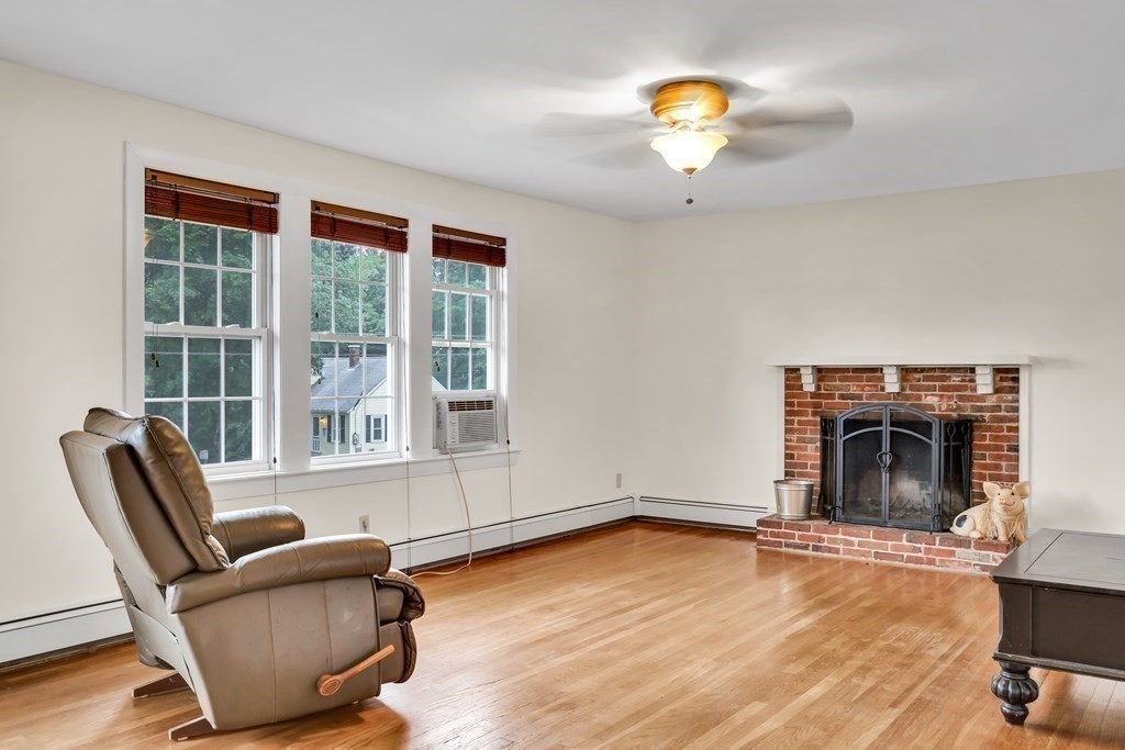 184 West Acton Road Stow, MA 01775 - Photo 10 of 35 a living room with furniture and a fireplace