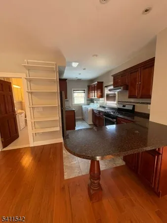 a view of kitchen and dining room with wooden floor