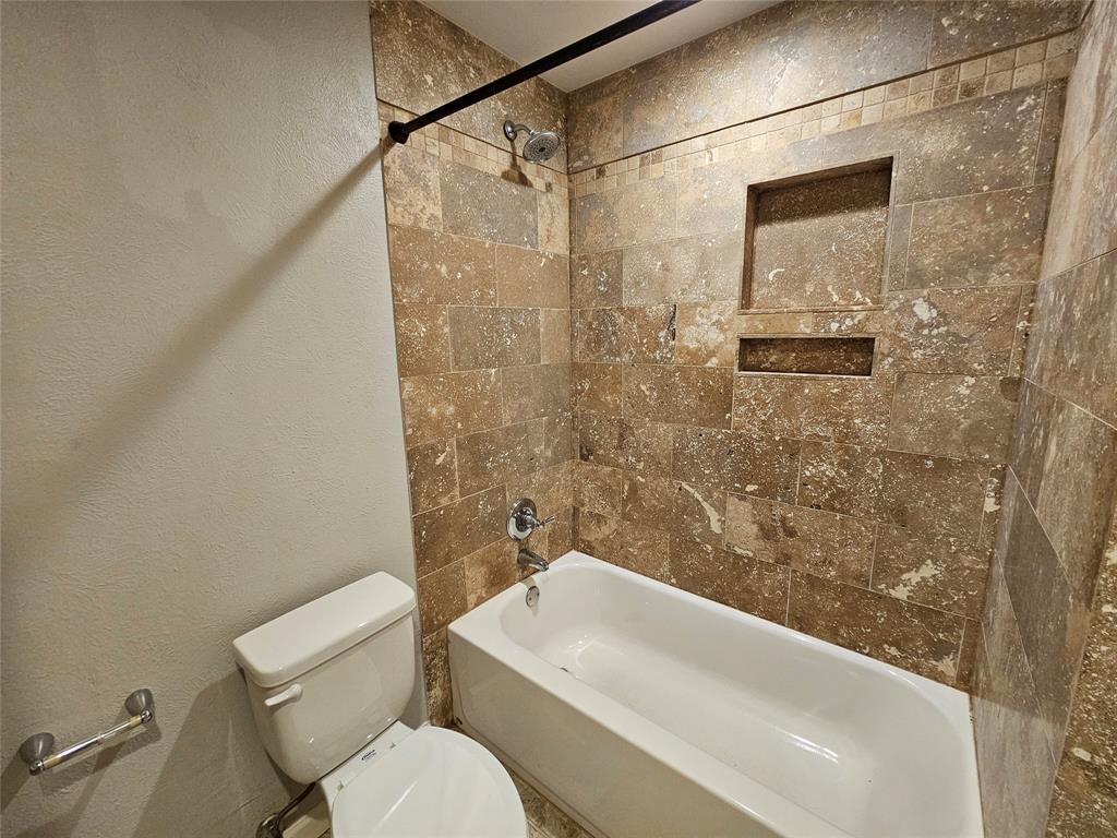 8601 Park Lane, Unit 522 Dallas, TX 75231 - Photo 13 of 21 a bathroom with a toilet and shower