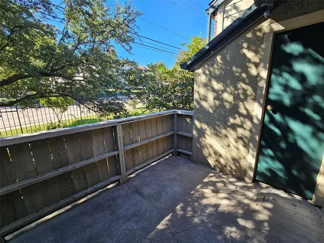 a view of backyard with wooden fence
