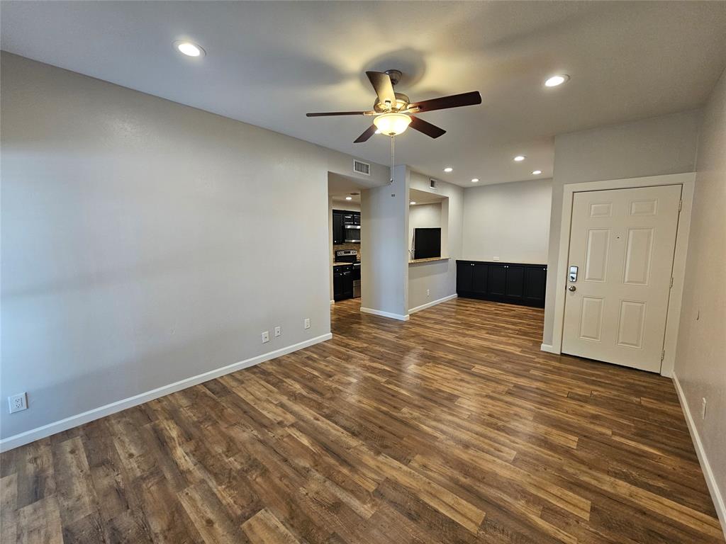 8601 Park Lane, Unit 522 Dallas, TX 75231 - Photo 5 of 21 a view of an empty room with a ceiling fan and window