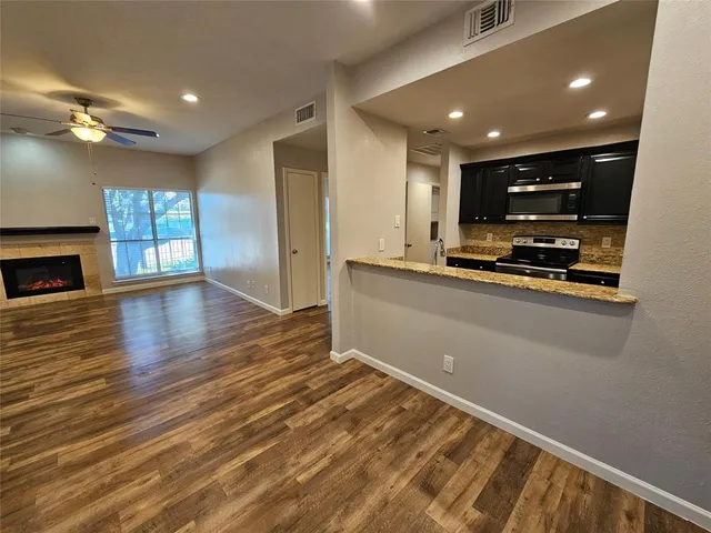 a view of kitchen with sink and microwave