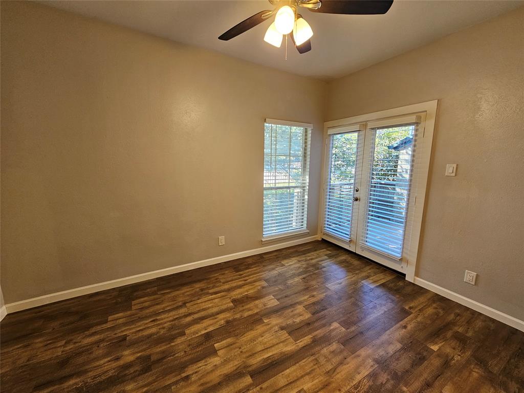 8601 Park Lane, Unit 522 Dallas, TX 75231 - Photo 9 of 21 an empty room with wooden floor and windows
