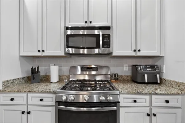 a stove top oven sitting inside of a kitchen