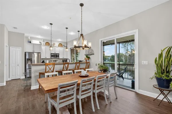 a dining room with furniture and wooden floor