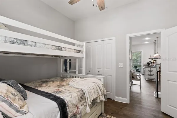 a bedroom with a large bed and wooden floor