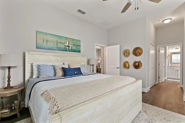 a bedroom with a large bed and a lamp