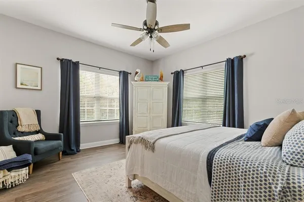 a bedroom with a bed a couch and a window