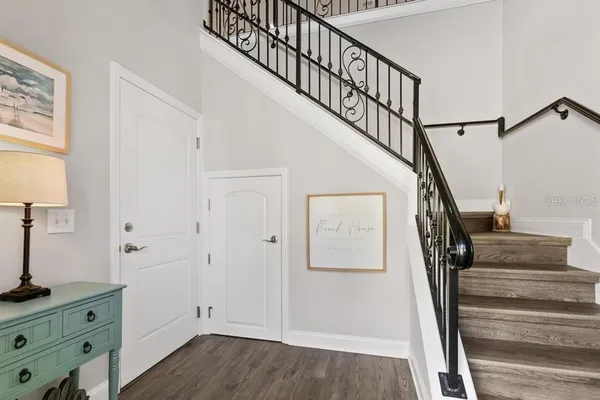 a view of entryway with wooden floor and stairs