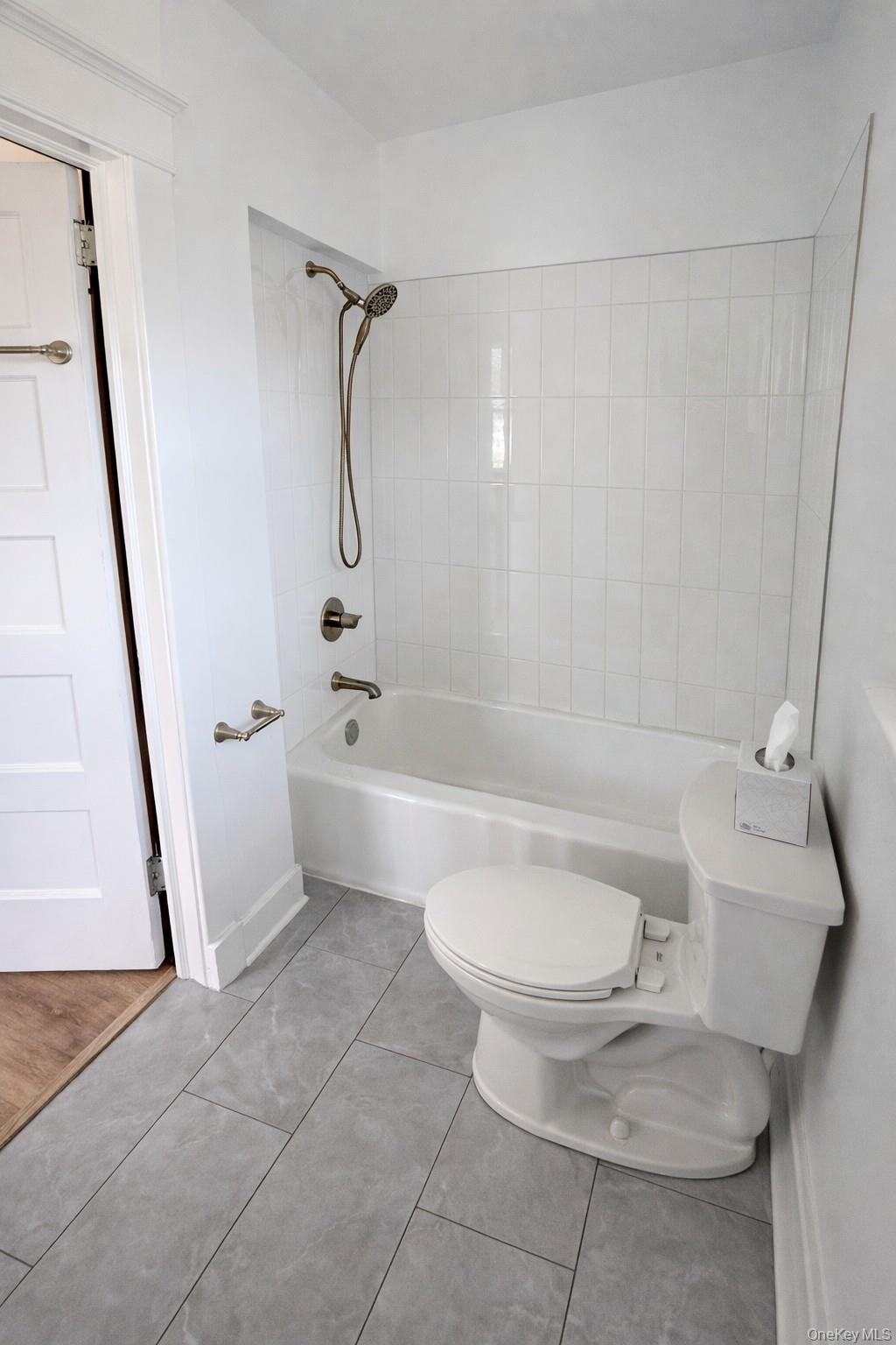 1009 Hudson Avenue, Unit 1S Peekskill, NY 10566 - Photo 12 of 21 a bathroom with a sink a toilet and a bathtub