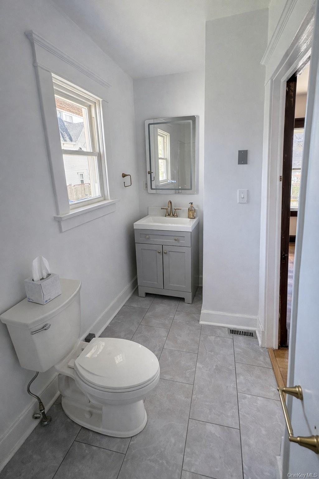 1009 Hudson Avenue, Unit 1S Peekskill, NY 10566 - Photo 13 of 21 a bathroom with a toilet a sink and mirror