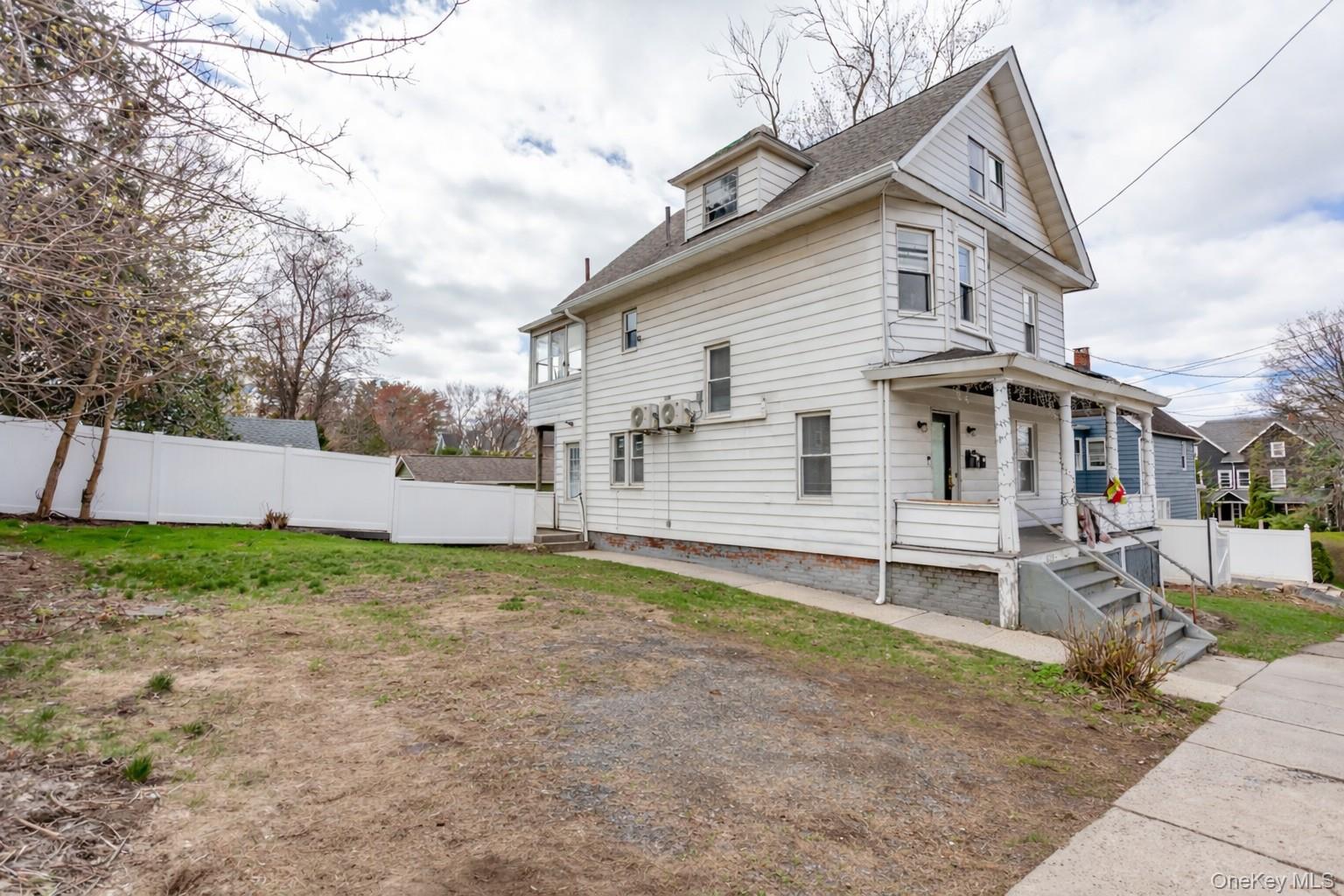 1009 Hudson Avenue, Unit 1S Peekskill, NY 10566 - Photo 2 of 21 a view of a house with a yard and a large tree