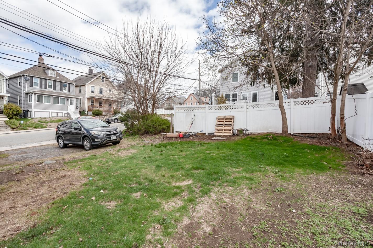 1009 Hudson Avenue, Unit 1S Peekskill, NY 10566 - Photo 21 of 21 a view of a white house that has a big yard plants and large trees