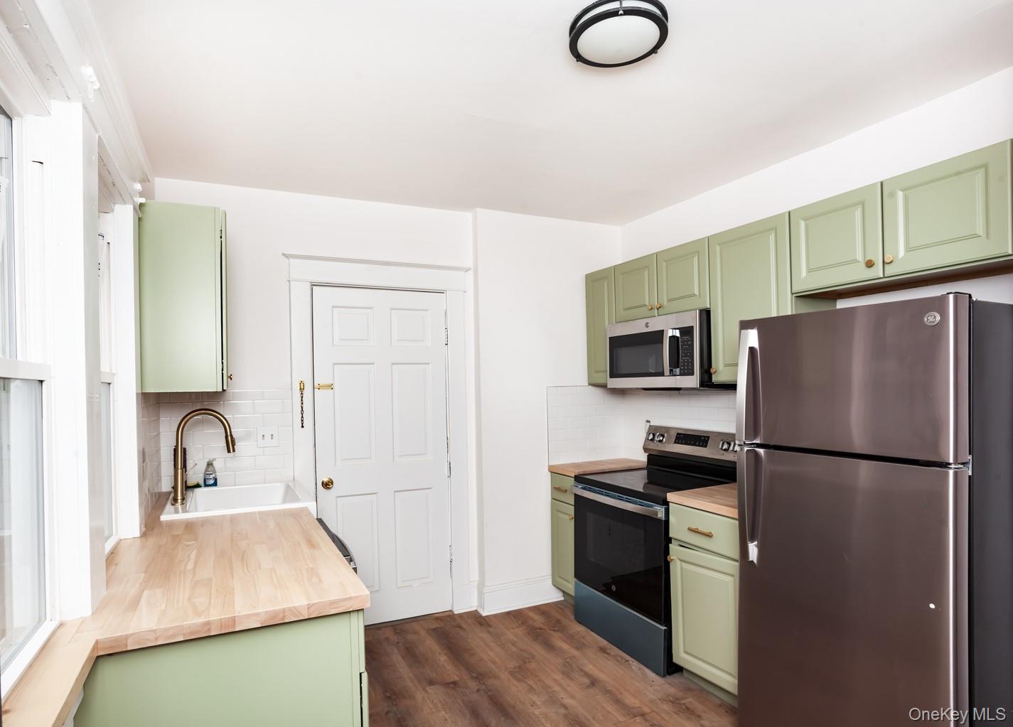 1009 Hudson Avenue, Unit 1S Peekskill, NY 10566 - Photo 6 of 21 a kitchen with a refrigerator and a sink