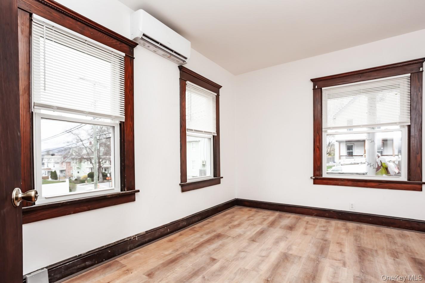 1009 Hudson Avenue, Unit 1S Peekskill, NY 10566 - Photo 7 of 21 a view of an empty room with a window and wooden floor