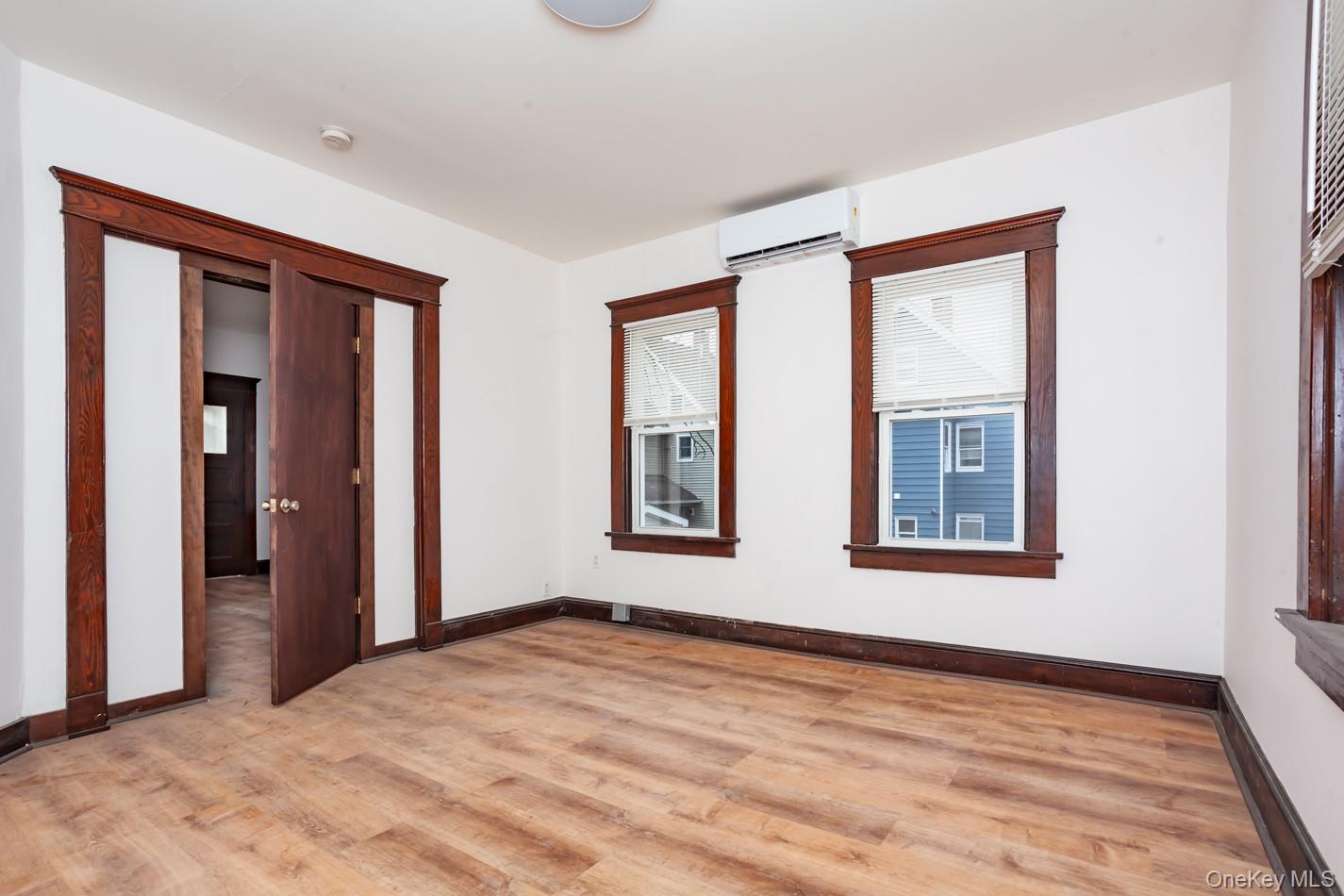 1009 Hudson Avenue, Unit 1S Peekskill, NY 10566 - Photo 9 of 21 a view of an empty room with wooden floor and a window