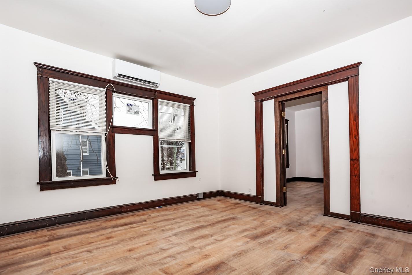 1009 Hudson Avenue, Unit 1S Peekskill, NY 10566 - Photo 10 of 21 a view of an empty room with window and wooden floor